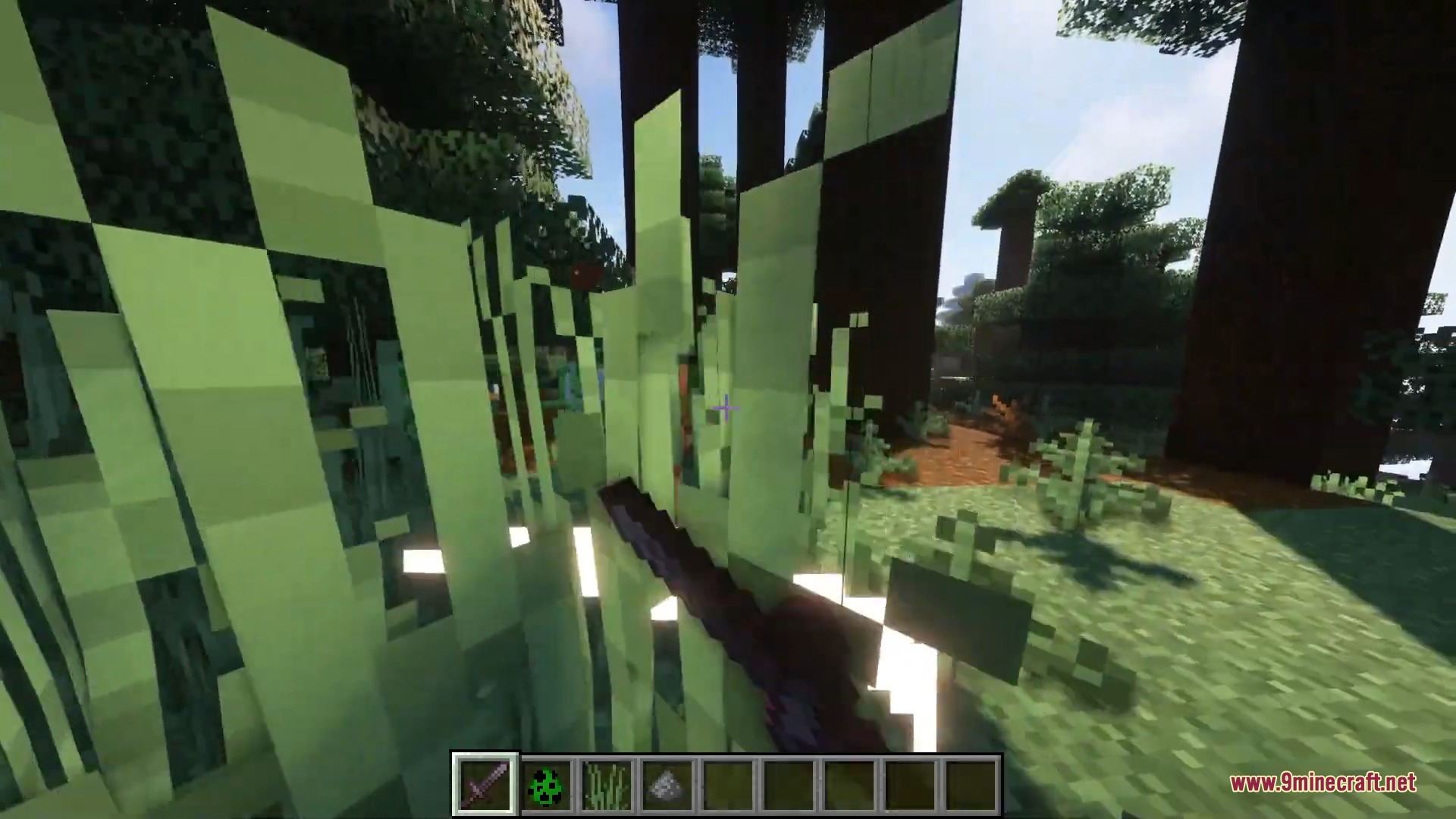 Player holding a sword while looking through tall grass in a forest