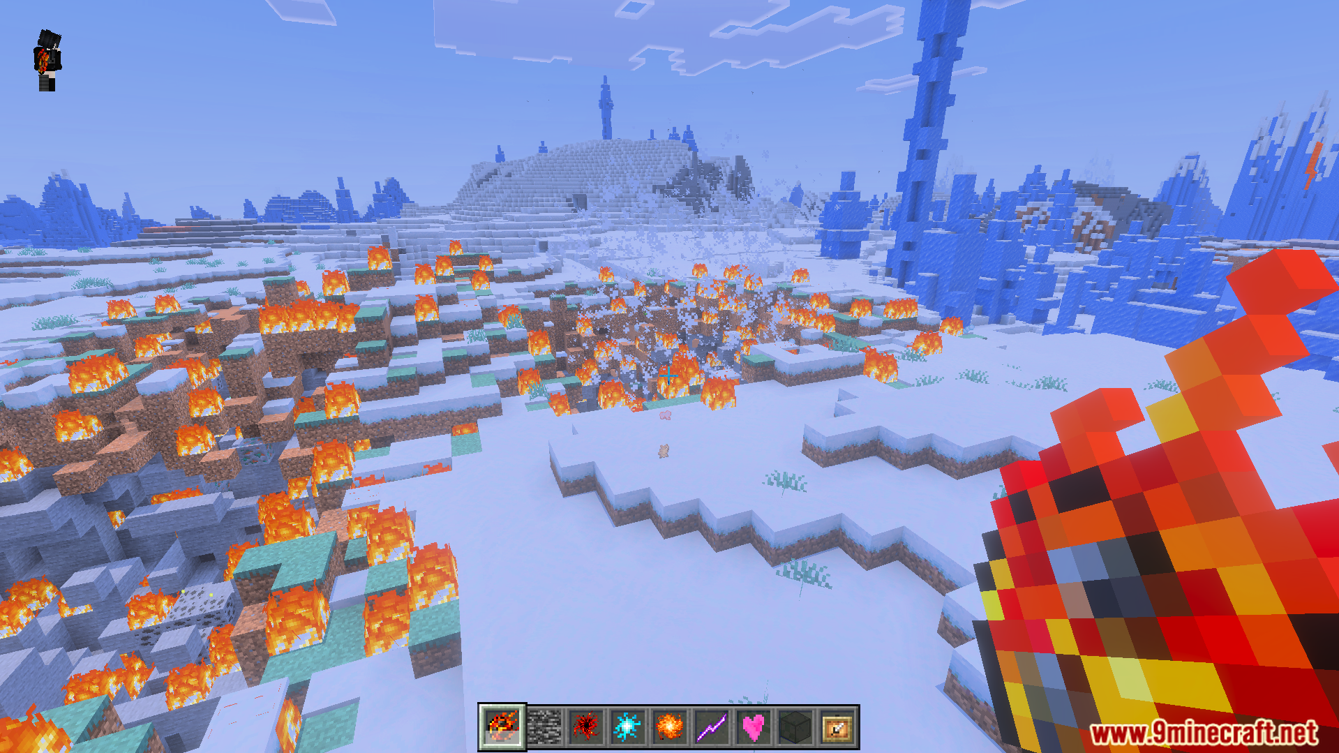 Player casting a fireball magic spell to create fire in a snowy biome