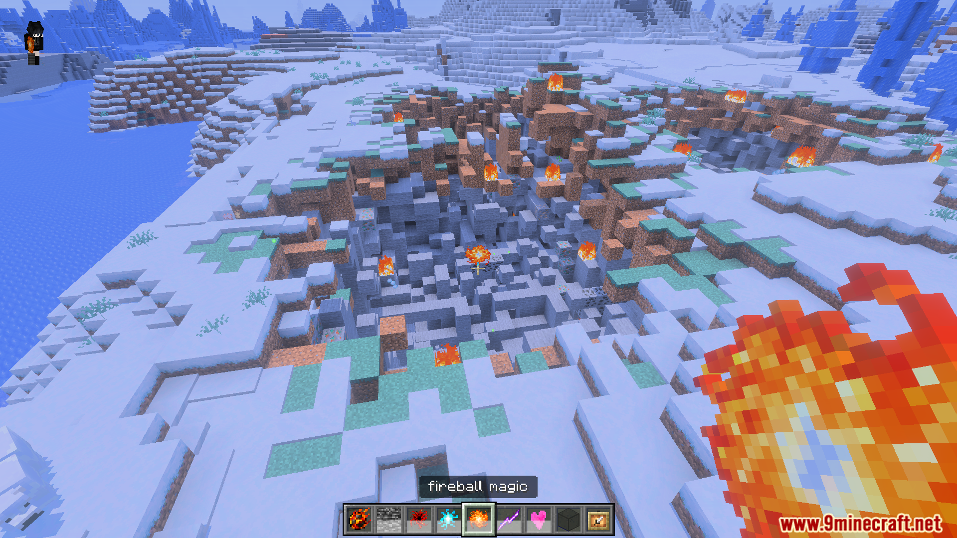 A player uses fireball magic to create a massive crater in snow