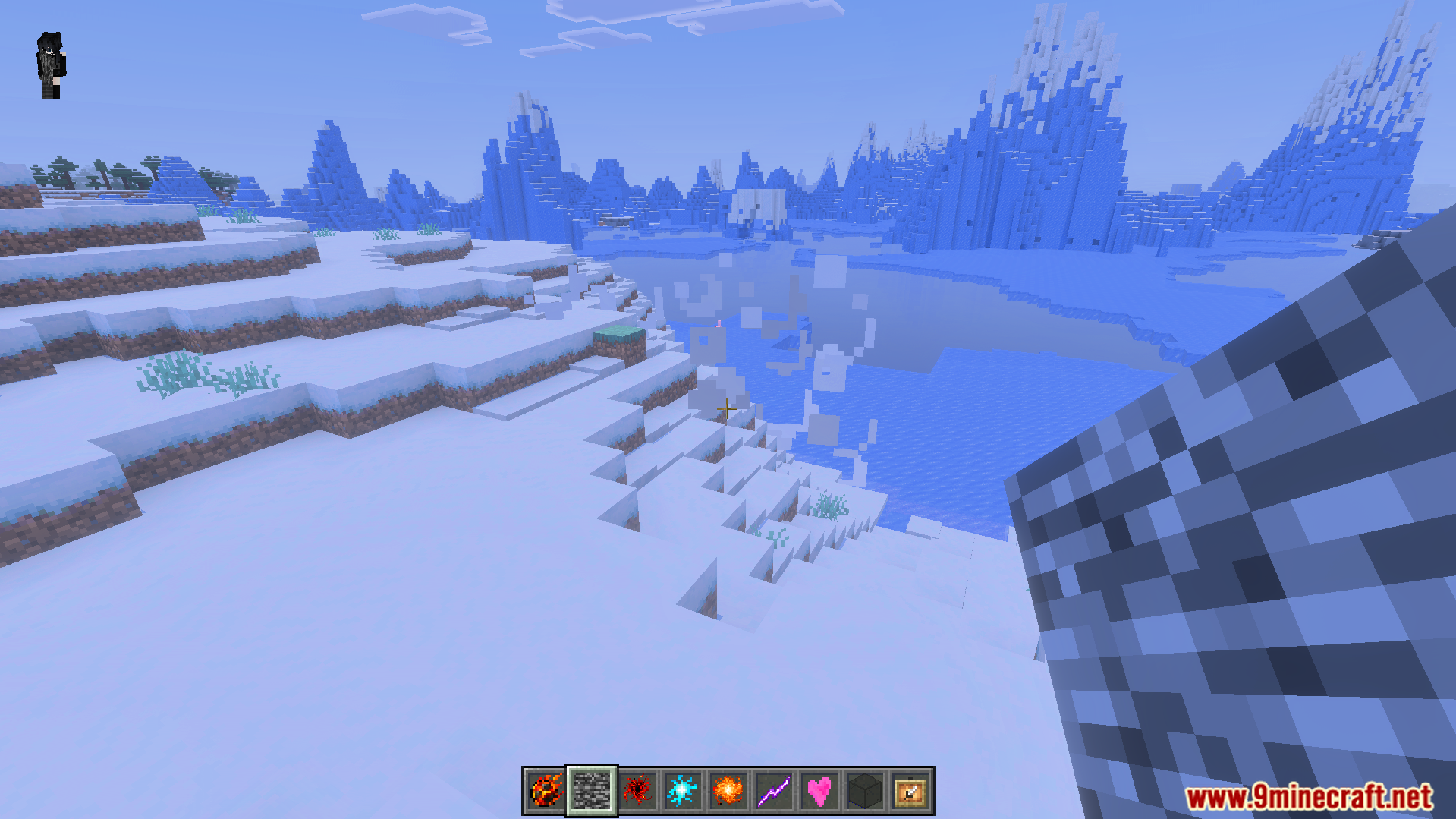 Snowy biome landscape with various magic items visible in the player hotbar