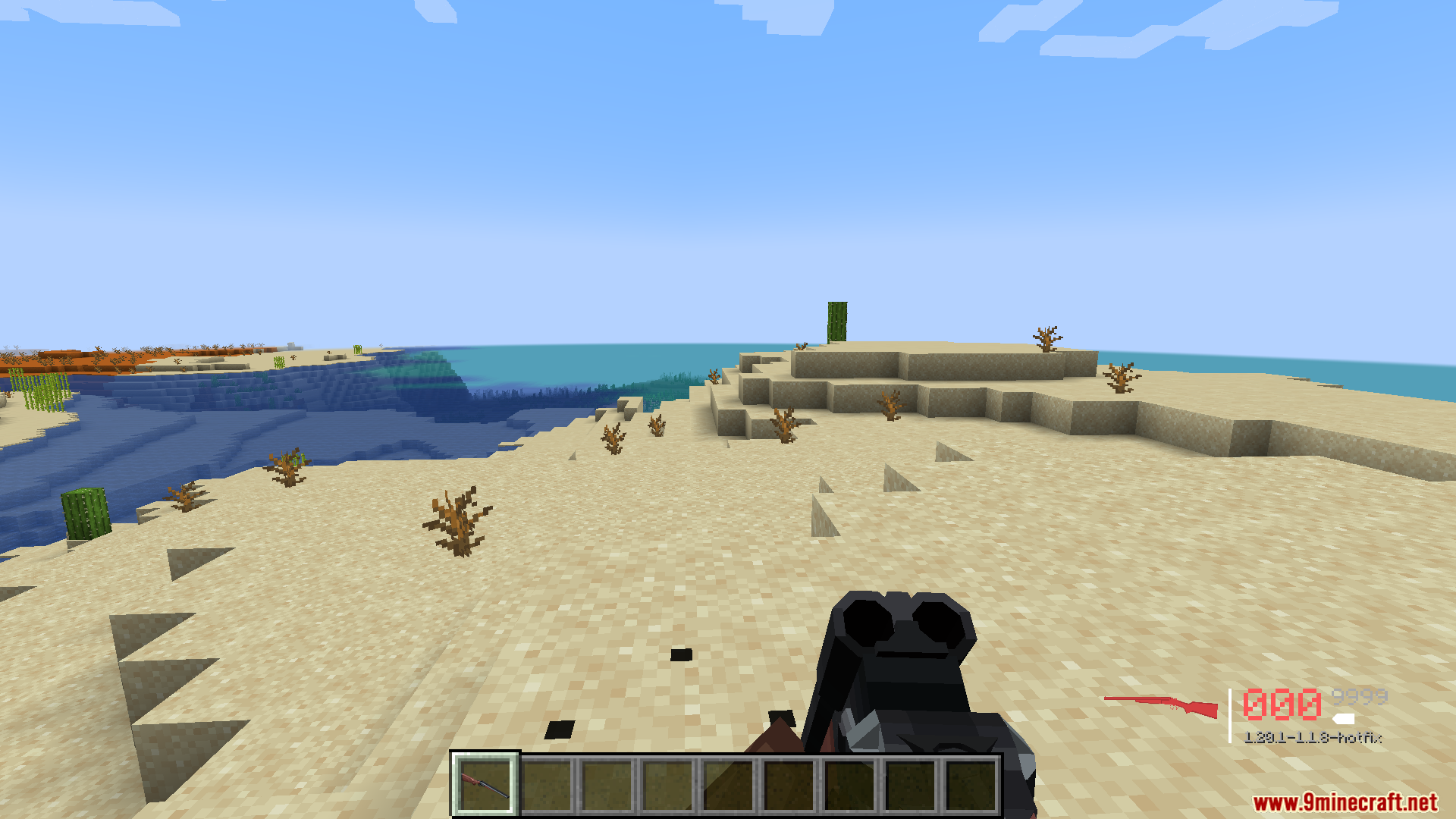 TACZ Endless Ammo Mod Screenshot 13 Player holding a double barreled shotgun in a desert biome near the ocean