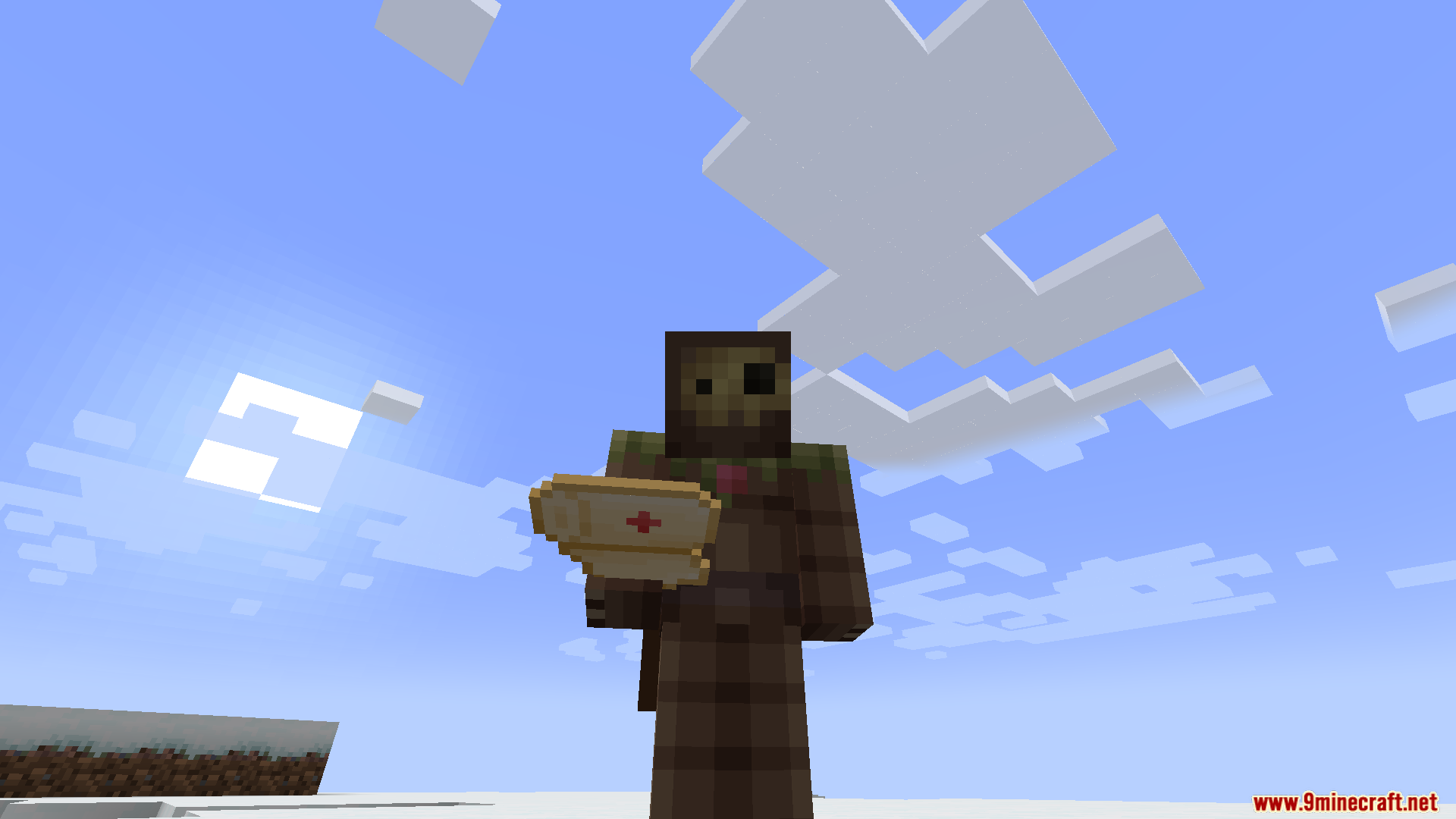 TACZ First Aid Compat Mod Screenshot 8 Minecraft character holding a medical first aid kit in a snowy landscape
