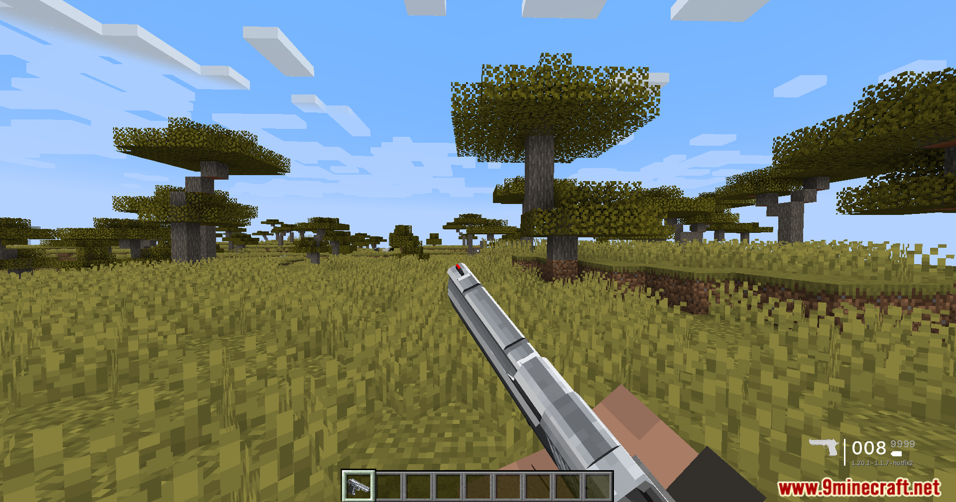 TaCZ Optimization Mod Screenshot 2 Player holding a silver pistol in first person view within a savanna