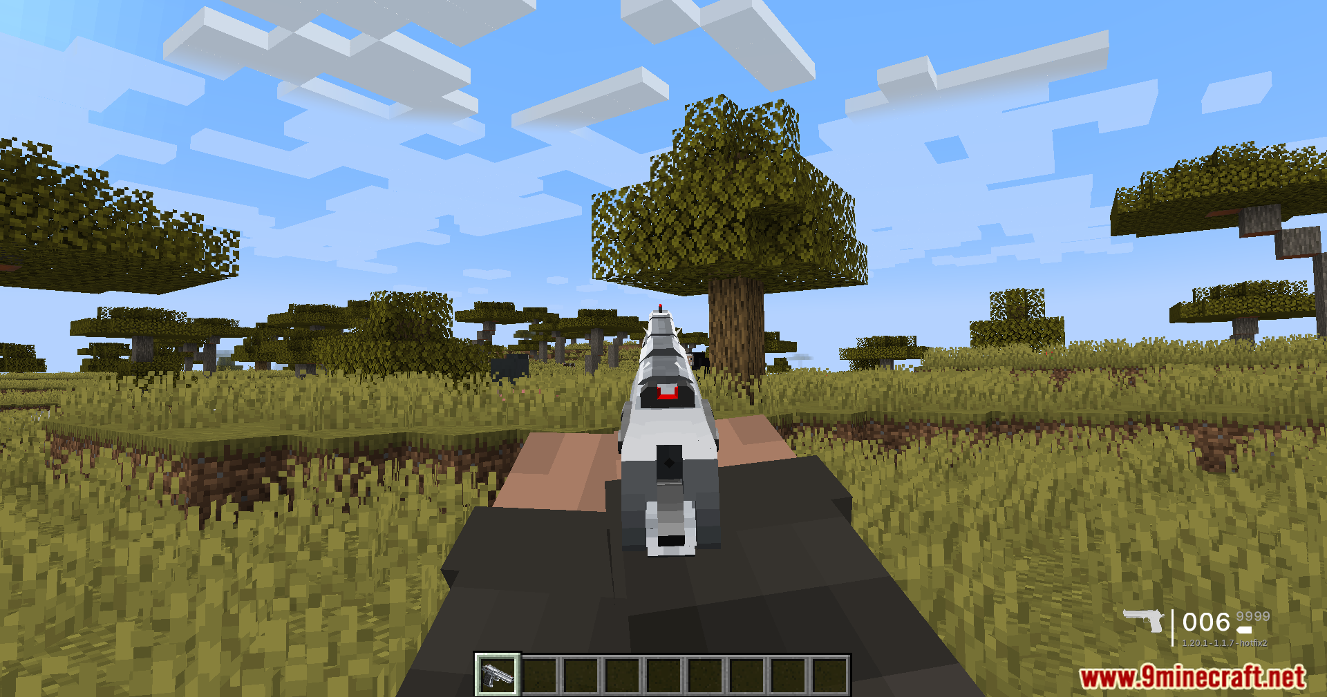 TaCZ Optimization Mod Screenshot 6 Player aiming down sights with a silver pistol in a Minecraft savanna biome