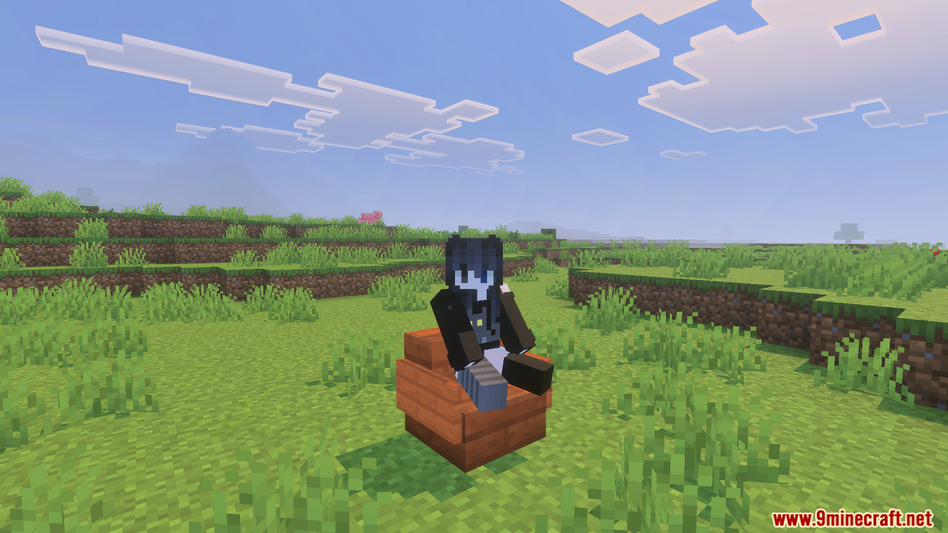 Player character sitting on a wooden chair in a green grassy field