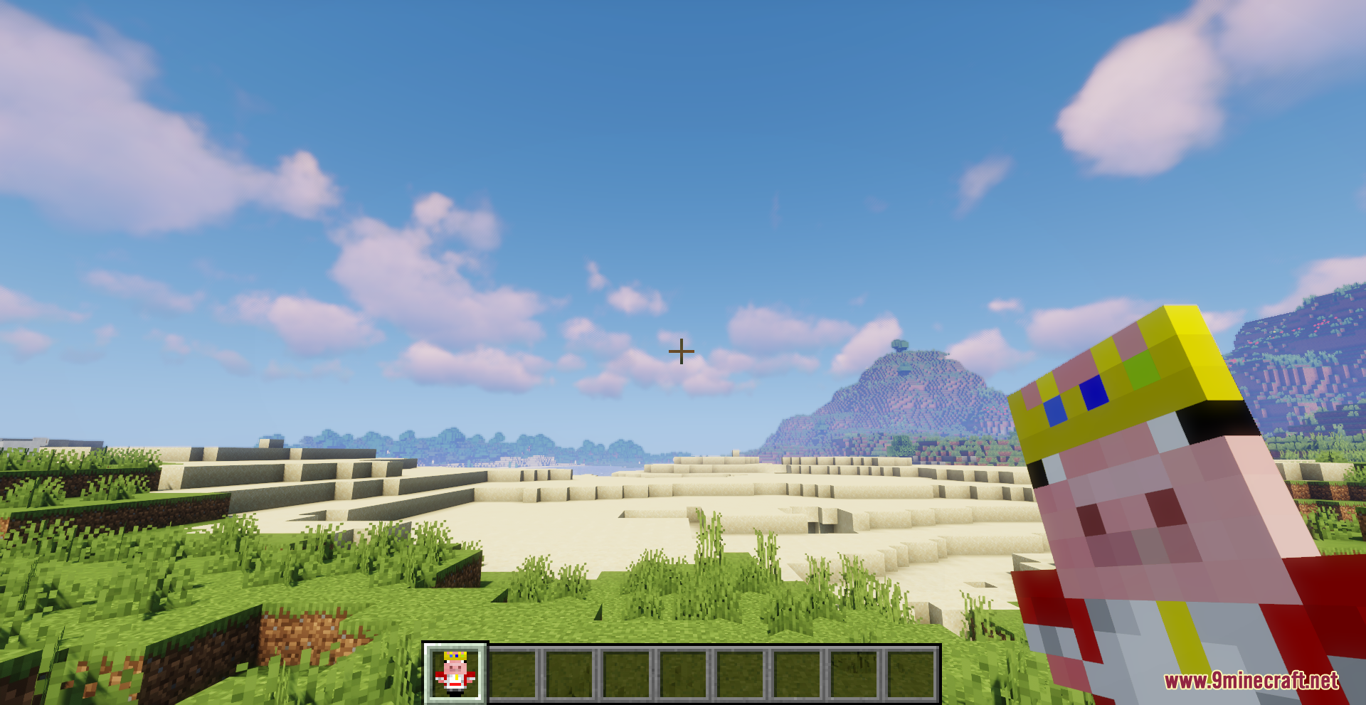 A player holds the Technoblade totem while exploring a vast desert landscape