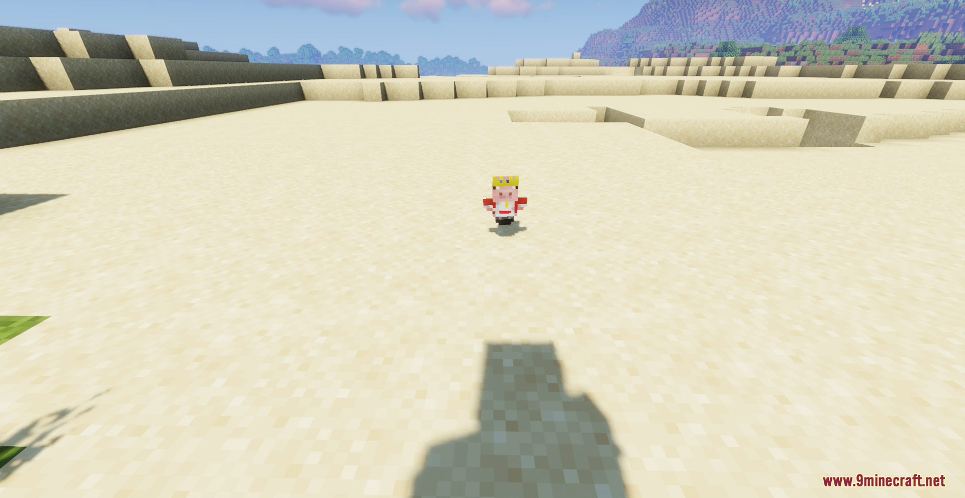 A small pig totem wearing a crown dropped on the desert sand