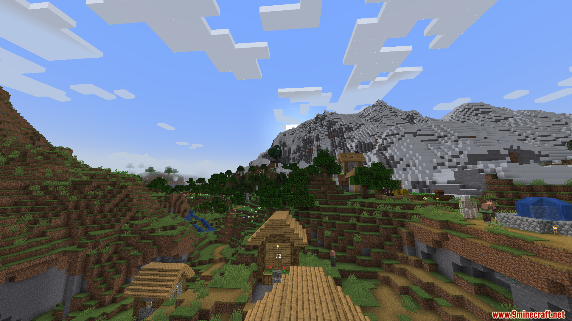 Thaumon PT BR Translation Resource Pack Screenshot 6 A villager and an iron golem near wooden houses in a mountain valley