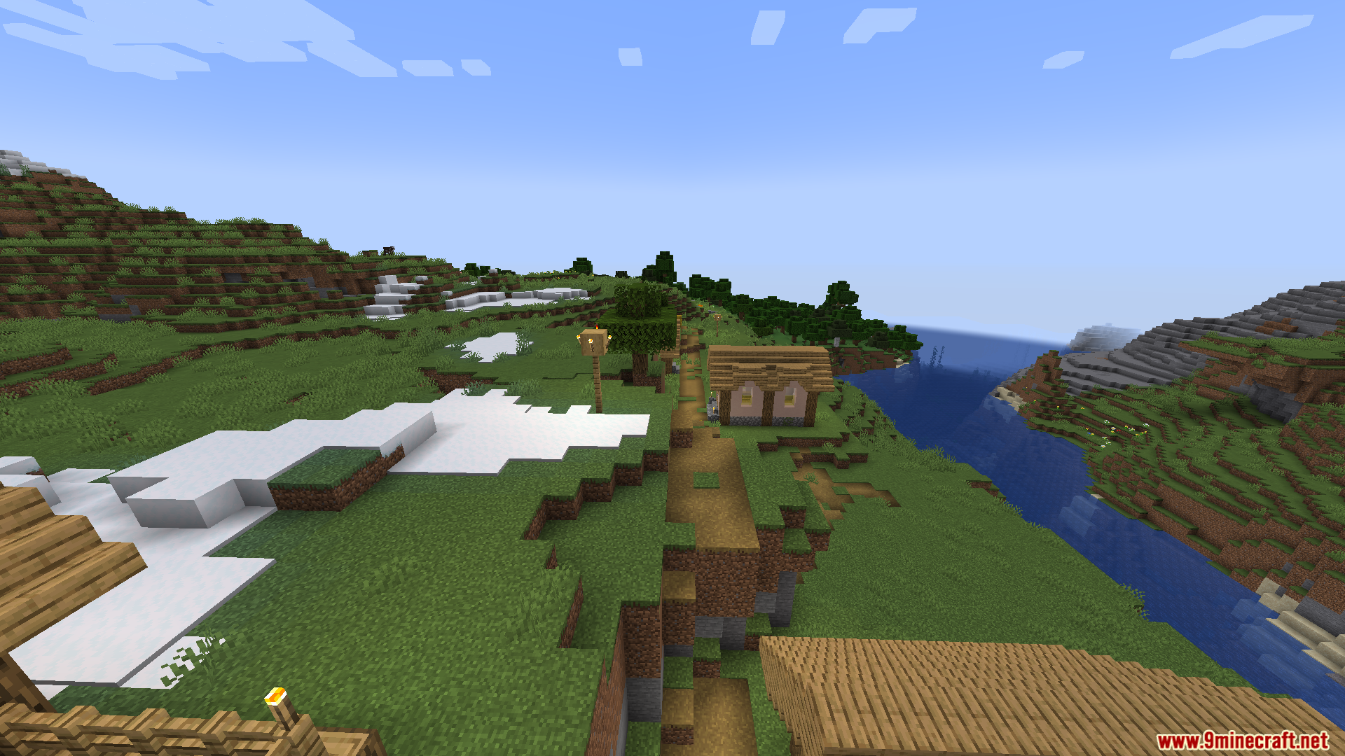 Thaumon PT BR Translation Resource Pack Screenshot 8 A dirt path winds past a wooden house near a river and snow