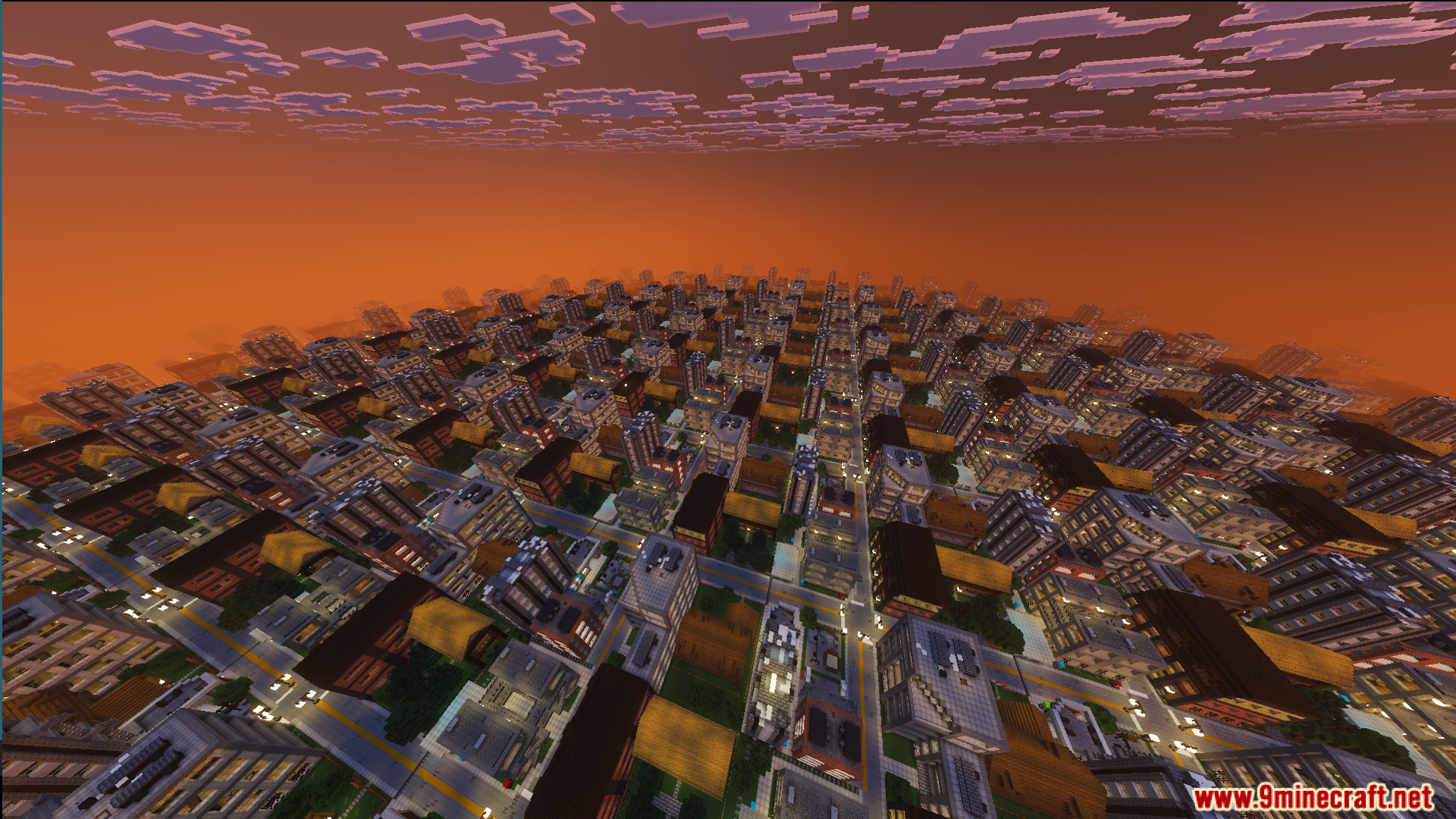 Wide perspective of endless avenues and buildings under a glowing orange sunset sky