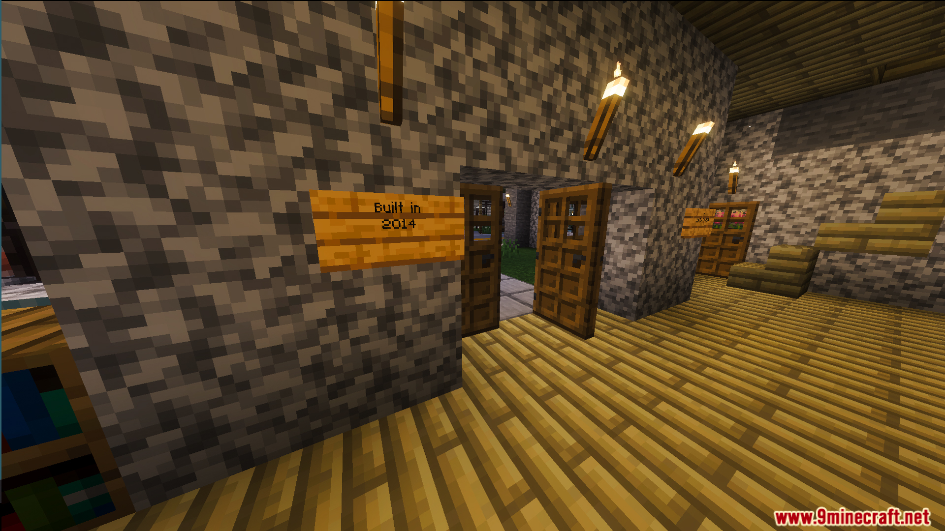 Interior of an apartment building with cobblestone walls and wooden floors