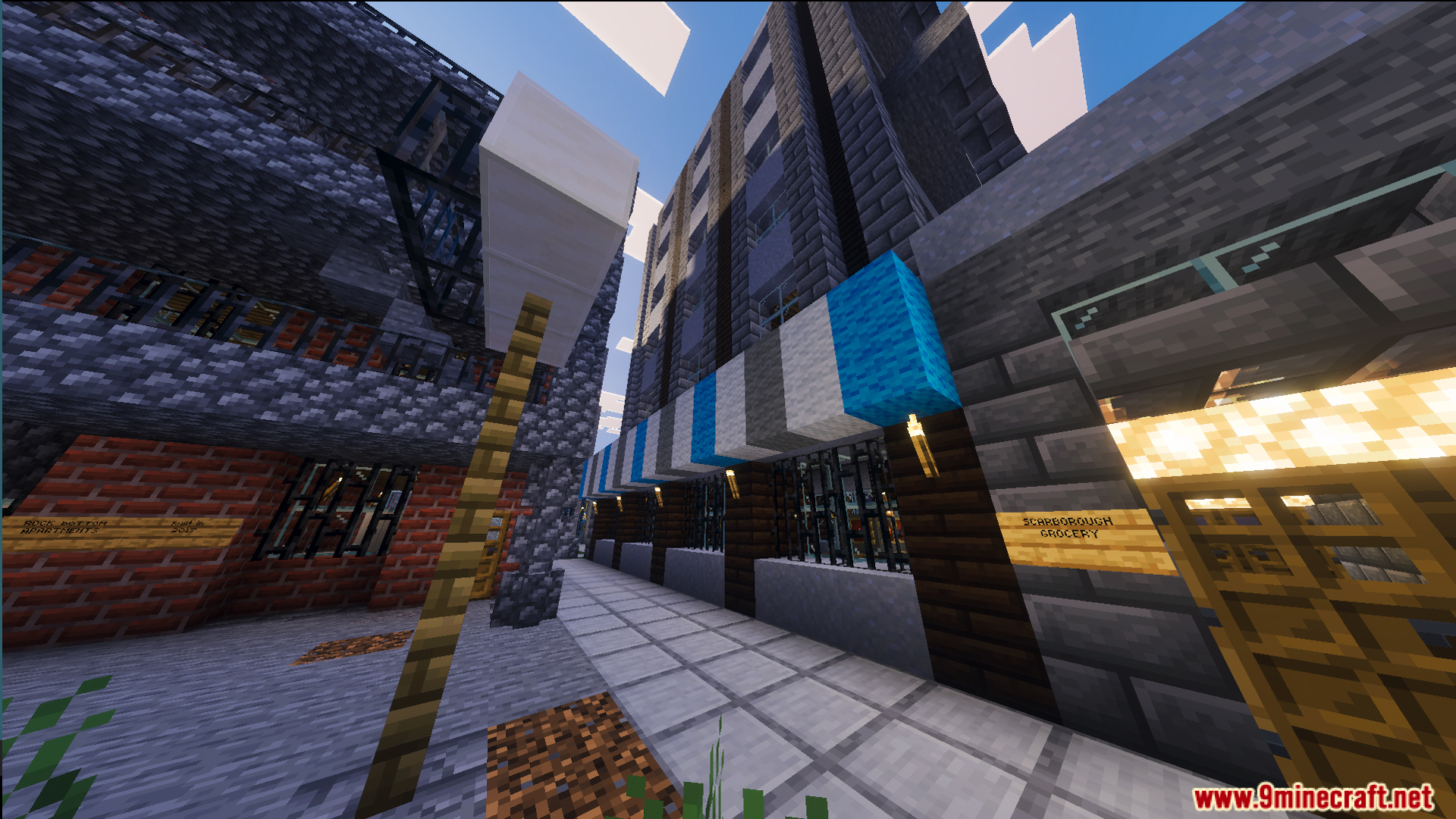 A quiet city street with brick buildings and a blue striped awning