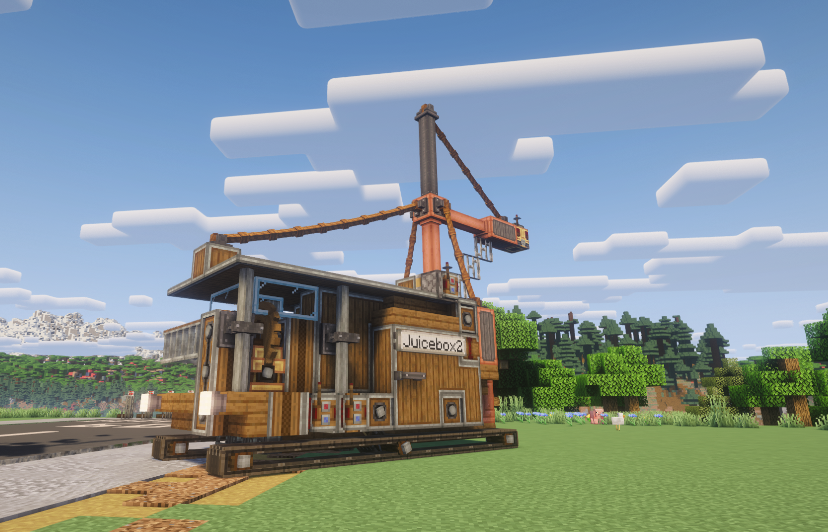 A refueling vehicle with a crane attachment parked in a grassy field