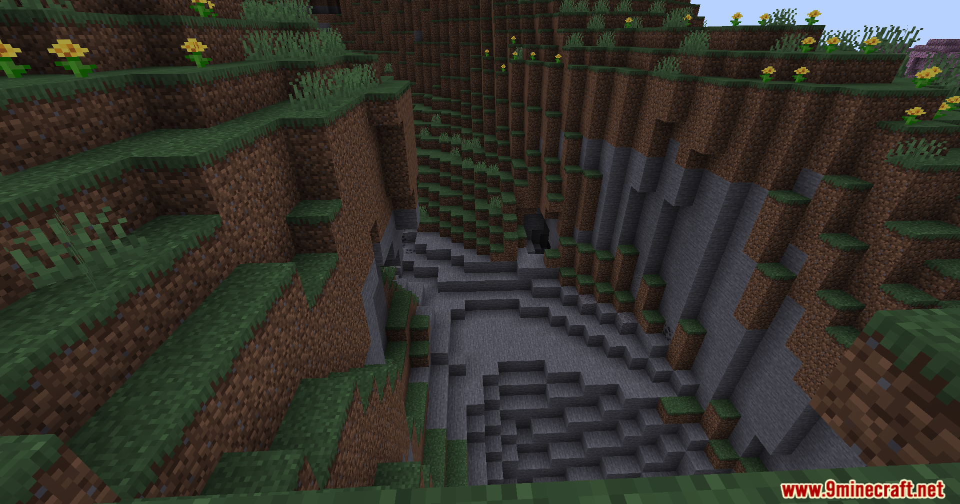 The Nofog Mod Screenshot 3 A deep Minecraft ravine with stone walls and yellow flowers on grass