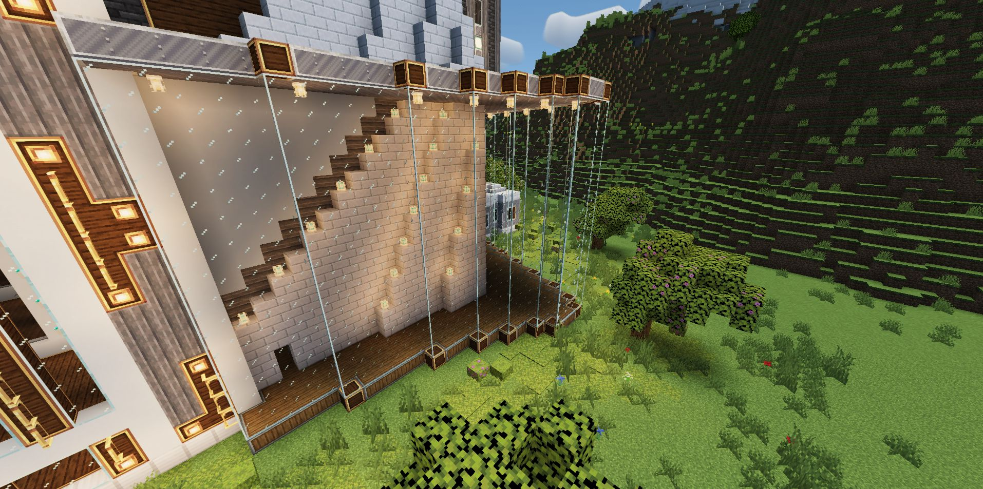 A stone staircase behind a glass wall with decorative lighting in Minecraft