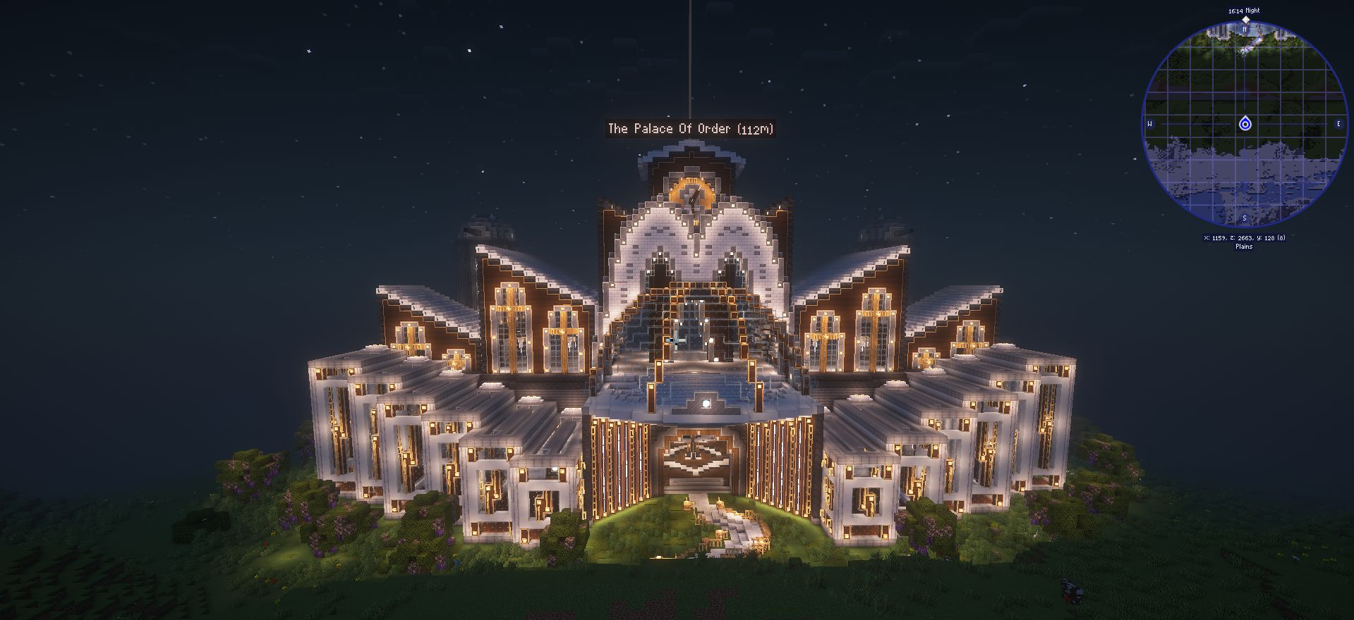 The Palace of Order illuminated with glowing lights and grand architectural details