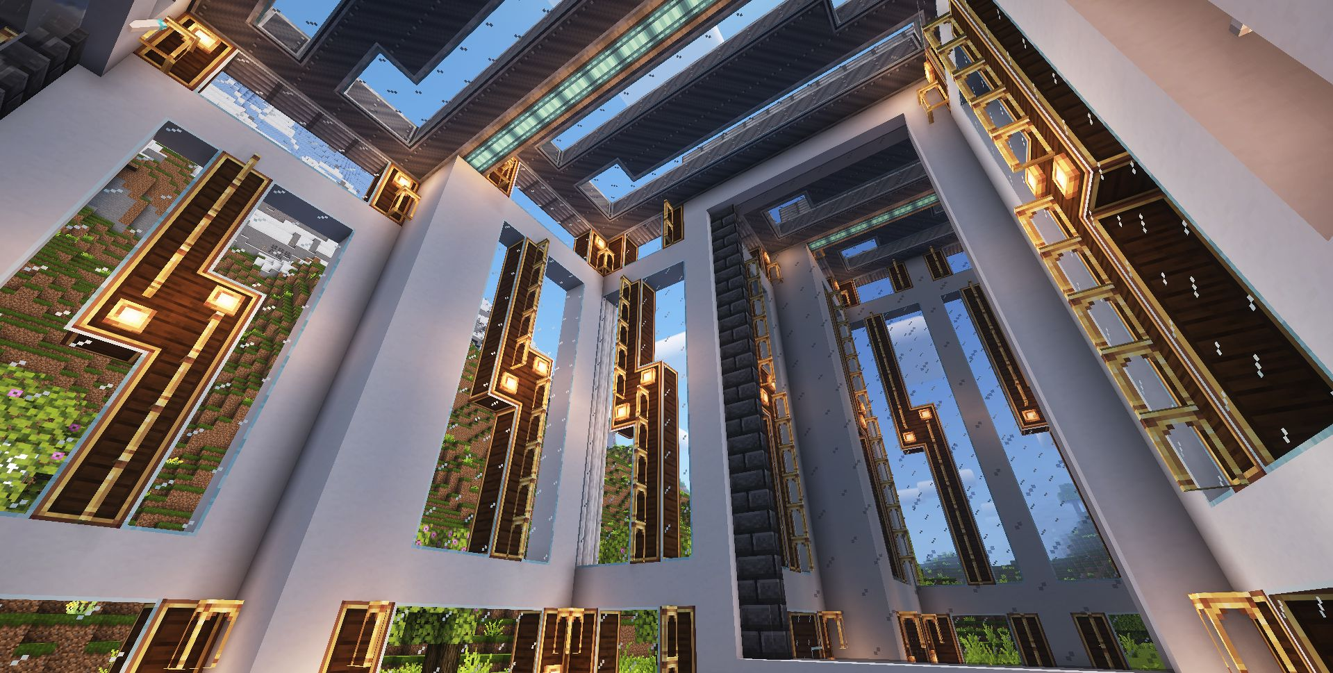 Sunlight shines through large patterned windows into a grand hall with high ceilings