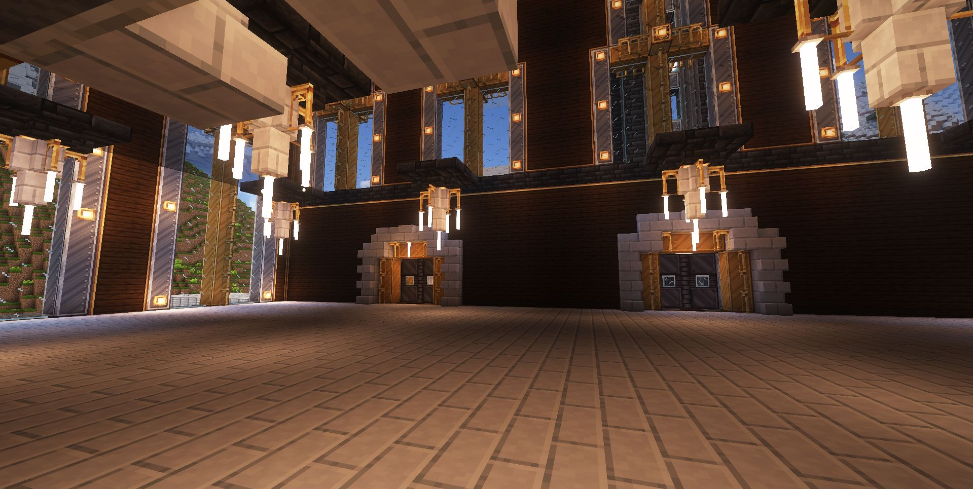Spacious hall with stone brick flooring and glowing chandeliers hanging from the ceiling