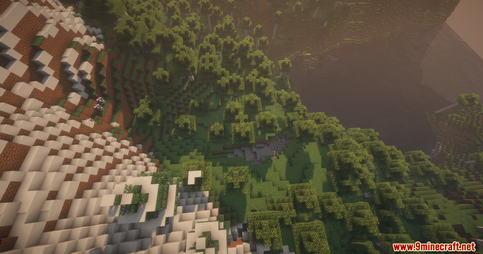 Thread Tweak Reforged Mod Screenshot 8 Aerial view of a snowy mountain slope transitioning into a lush green forest
