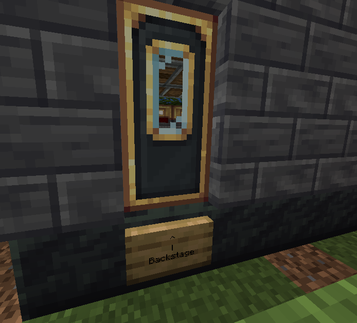 Single dark door with gold trim on stone wall above a backstage sign