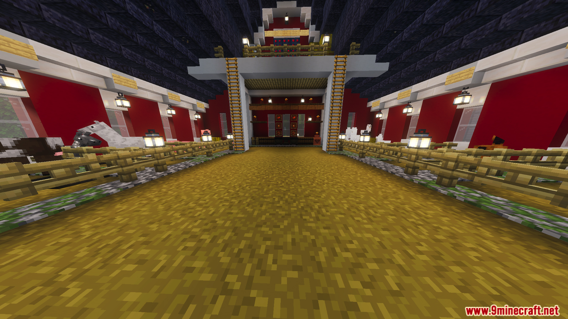 Inside a red barn with animal pens lit by hanging lanterns and wooden fences