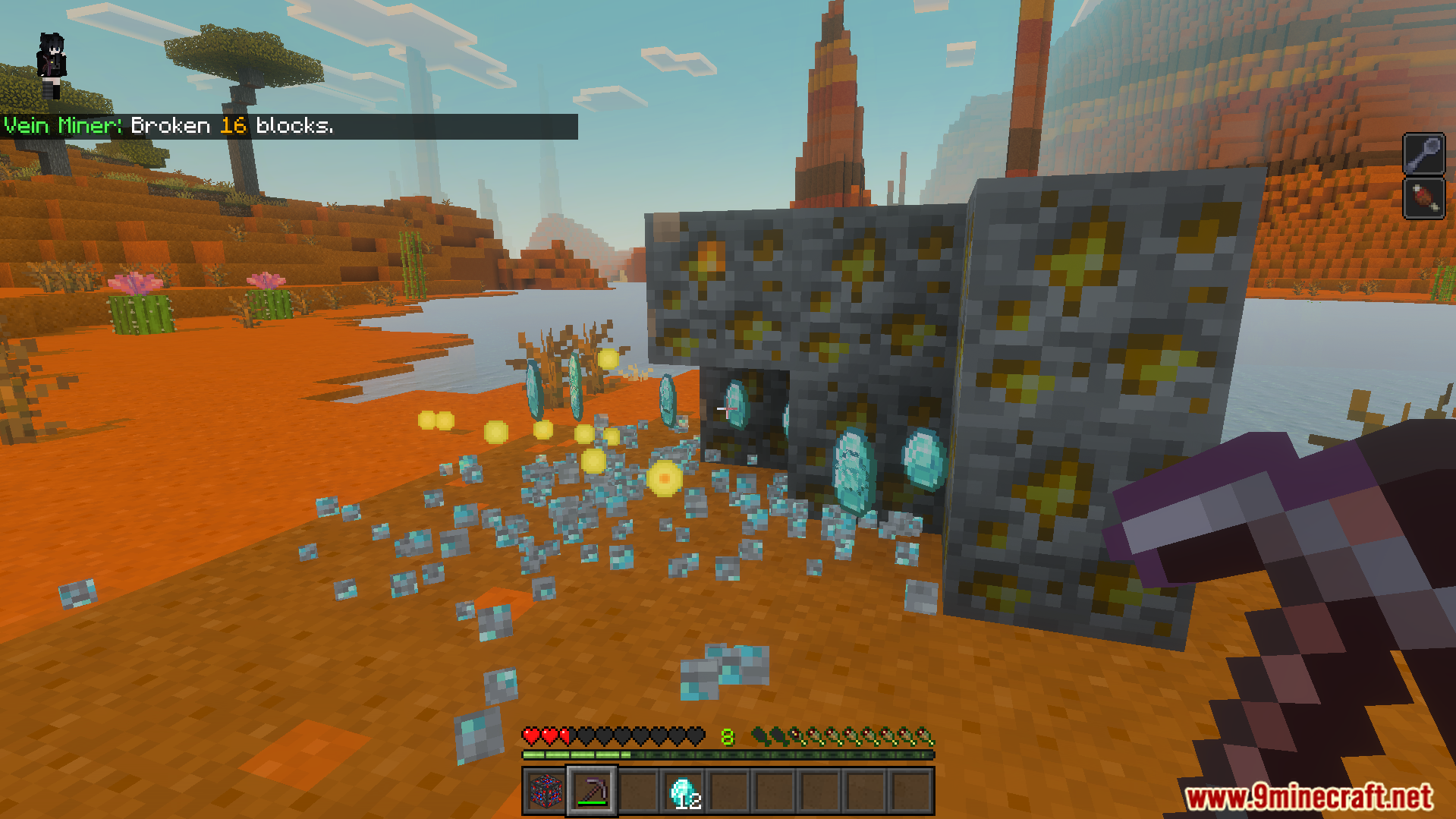 Mining gold ore blocks while diamonds and experience orbs drop on ground