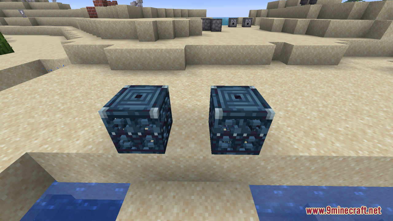 Two 3D trial spawner blocks placed on a sandy beach near water