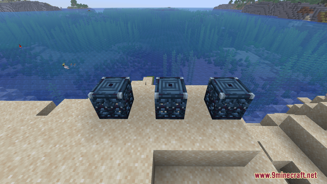 Three 3D trial spawner blocks sitting on sand by the ocean shore