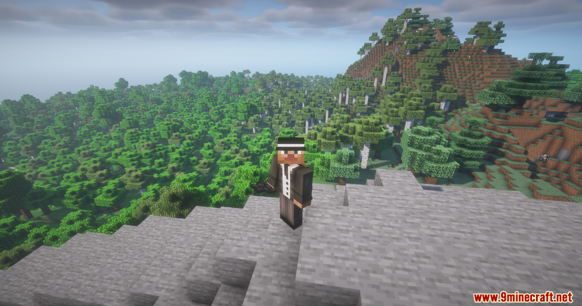 Utility Vest Mod Screenshot 7 A Minecraft character wearing a formal suit stands on a high stone cliff