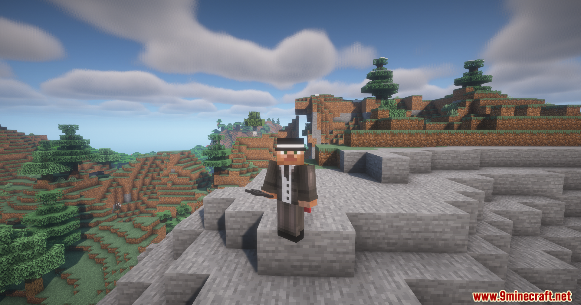 Utility Vest Mod Screenshot 9 A Minecraft player wearing a suit and hat stands on a rocky cliff