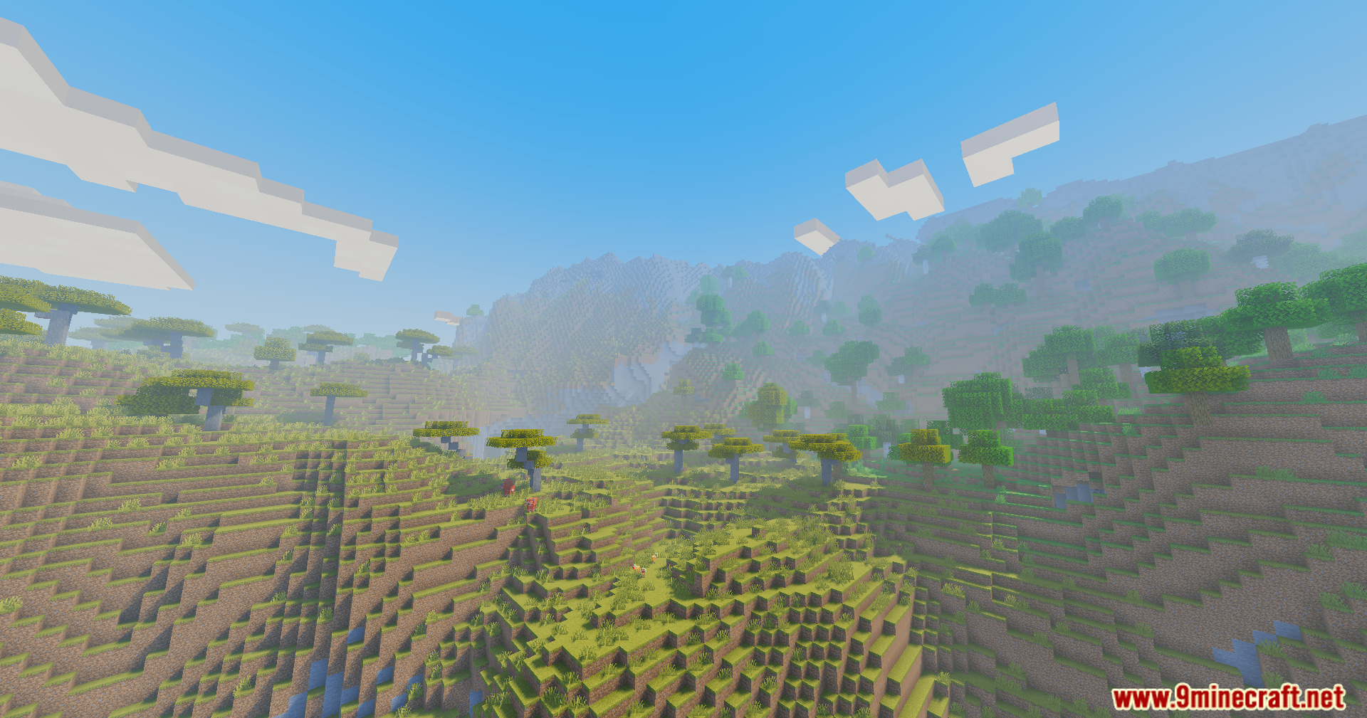 Sunlit hills and scattered trees in a bright Minecraft world with soft fog