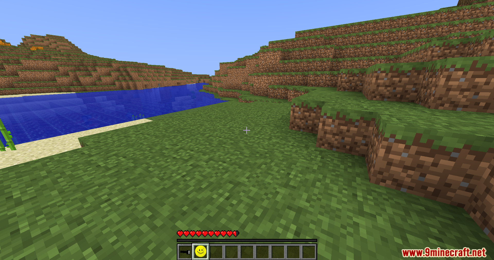 Verity Shaders Screenshot 9 A player standing on grass near water with a smiley face item selected