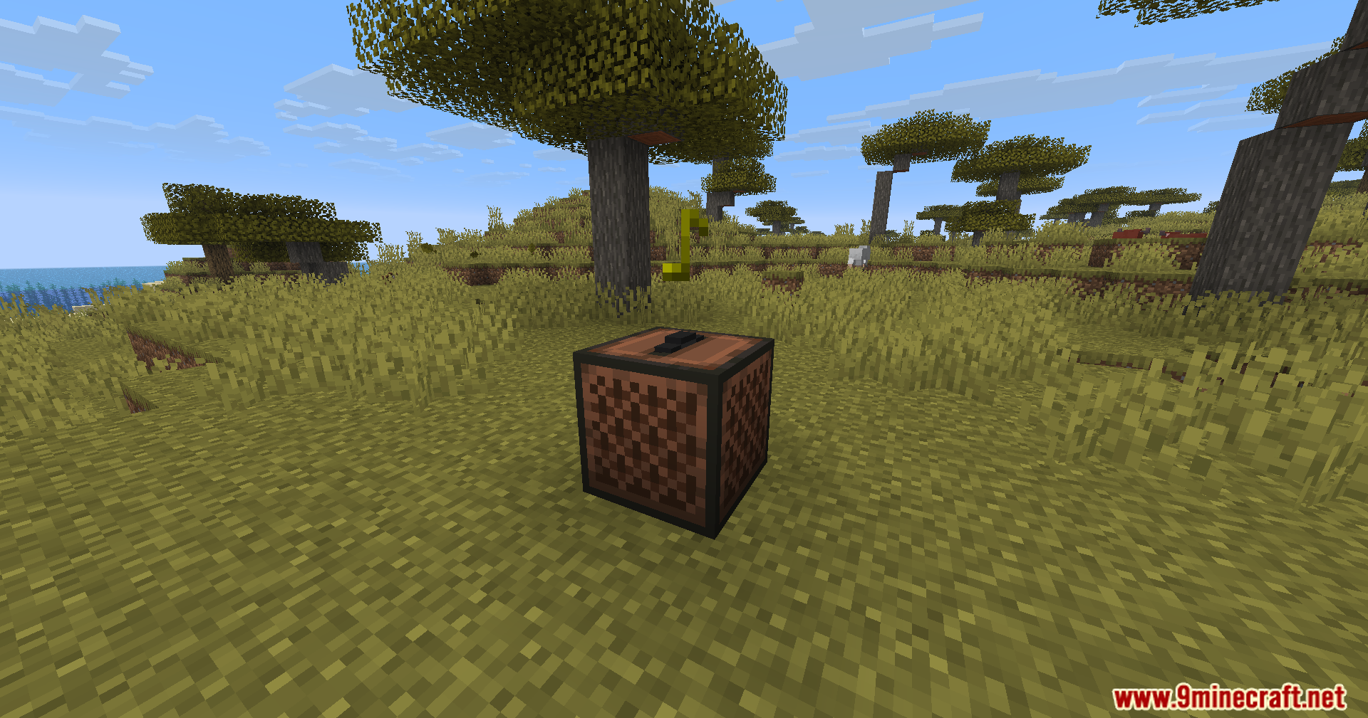 A black music disc sits on top of a jukebox in a savanna
