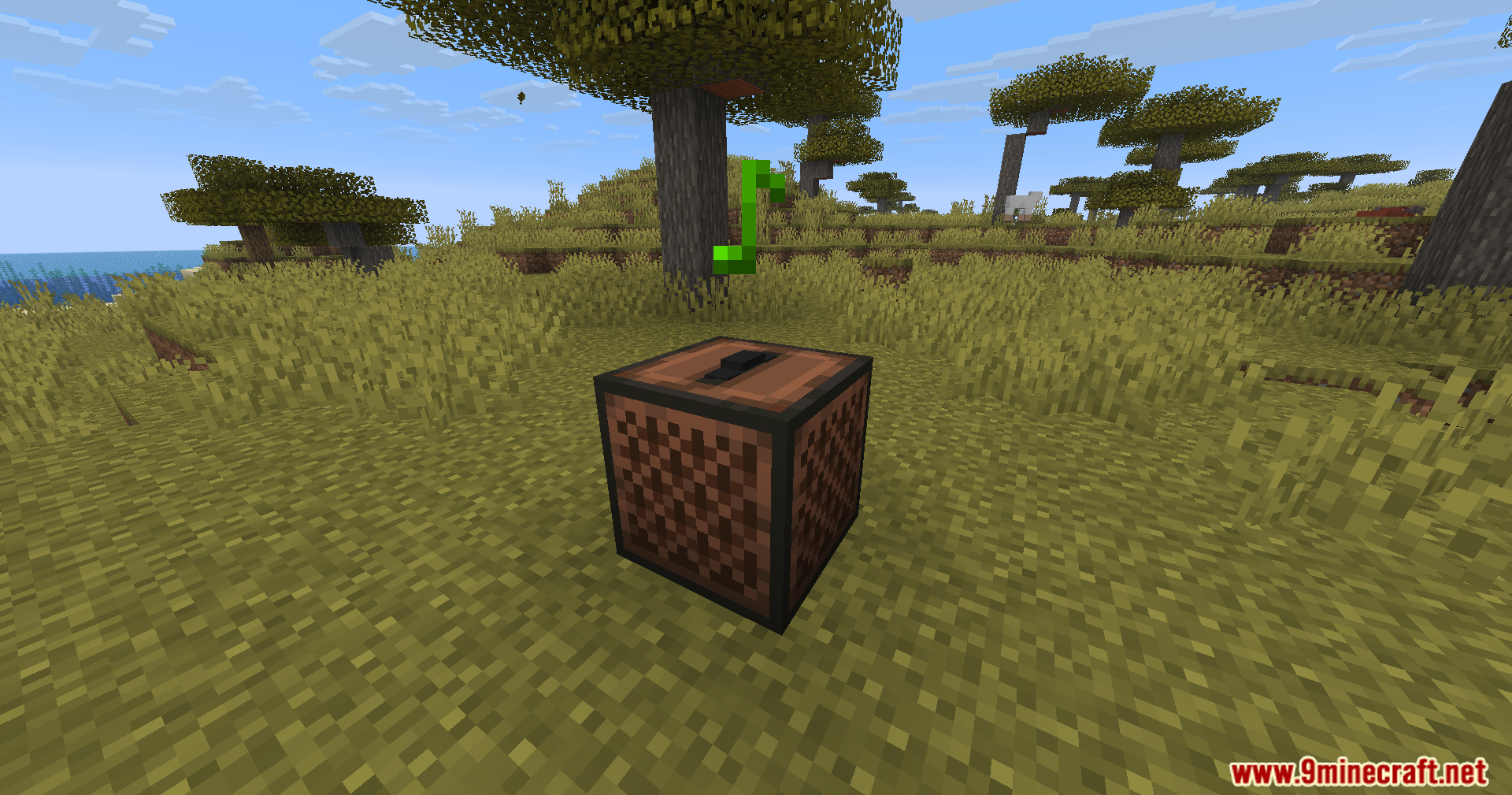 A jukebox block in a savanna biome with a green music note