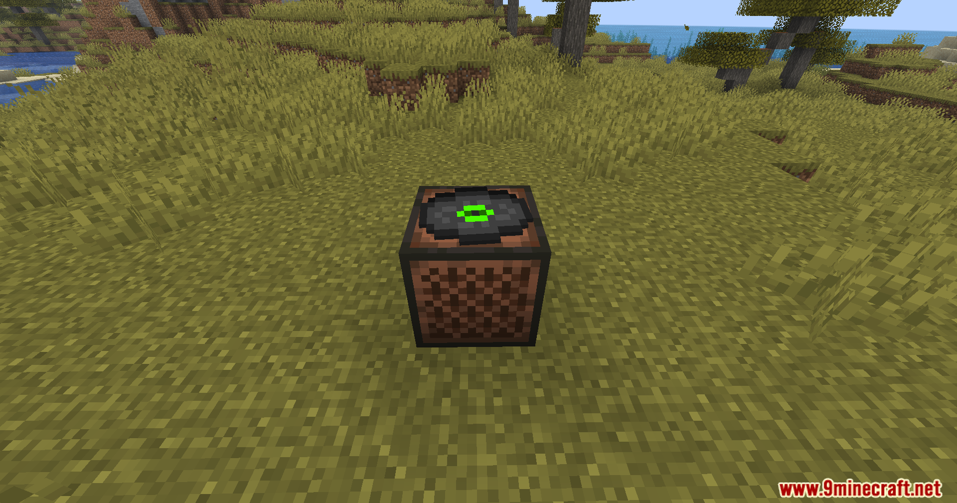 A green music disc resting on top of a jukebox in the savanna