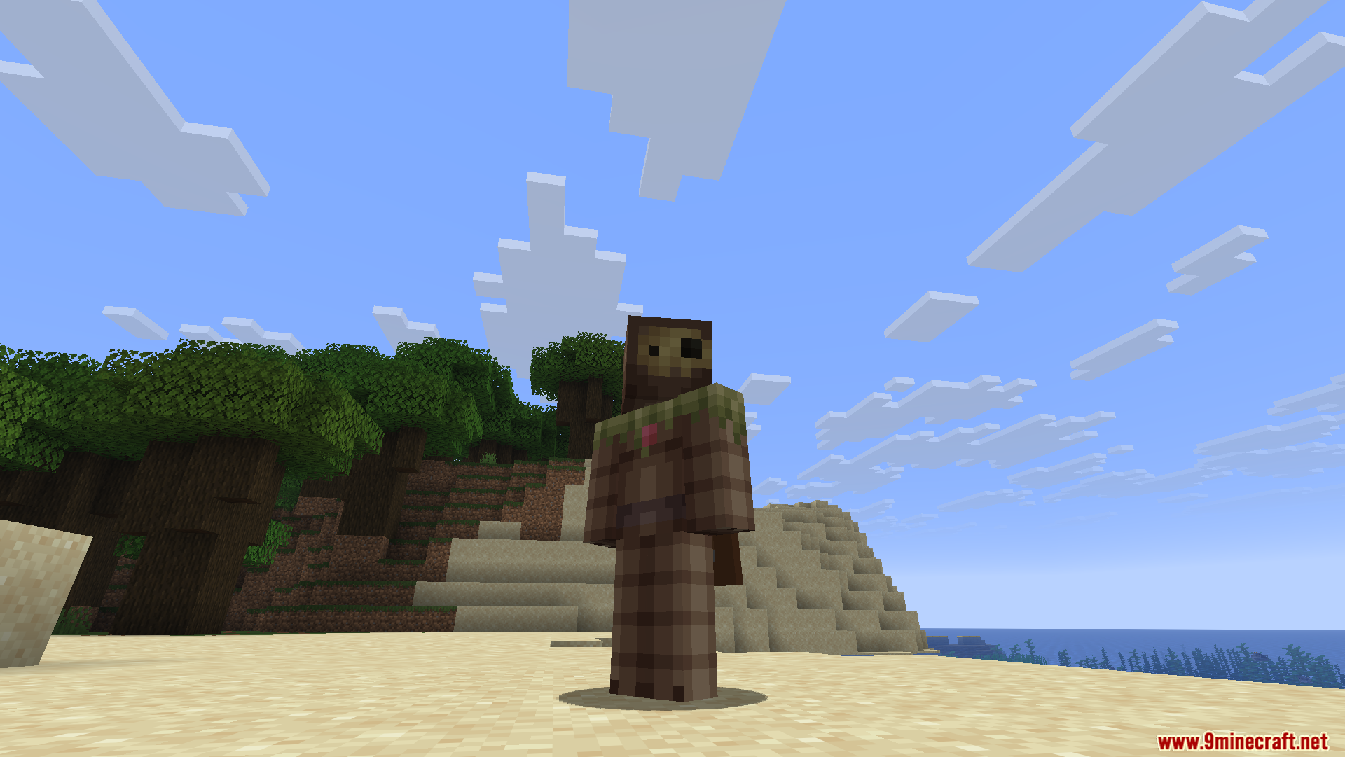 A wooden character skin stands still on a sandy beach near the ocean