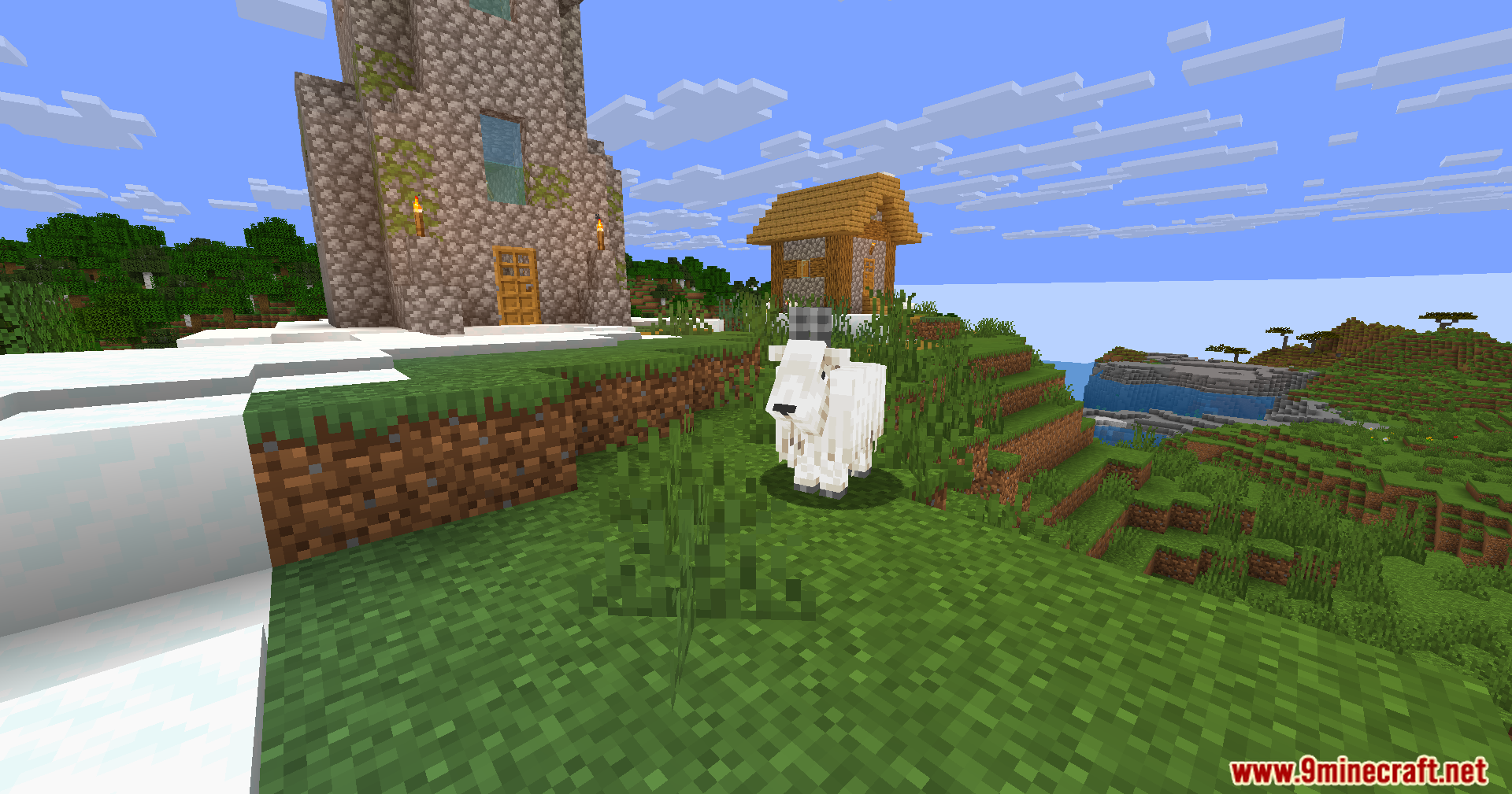 Wozt Vanilla Plus Shaders Screenshot 5 A white goat stands on a grassy hill near a cobblestone church