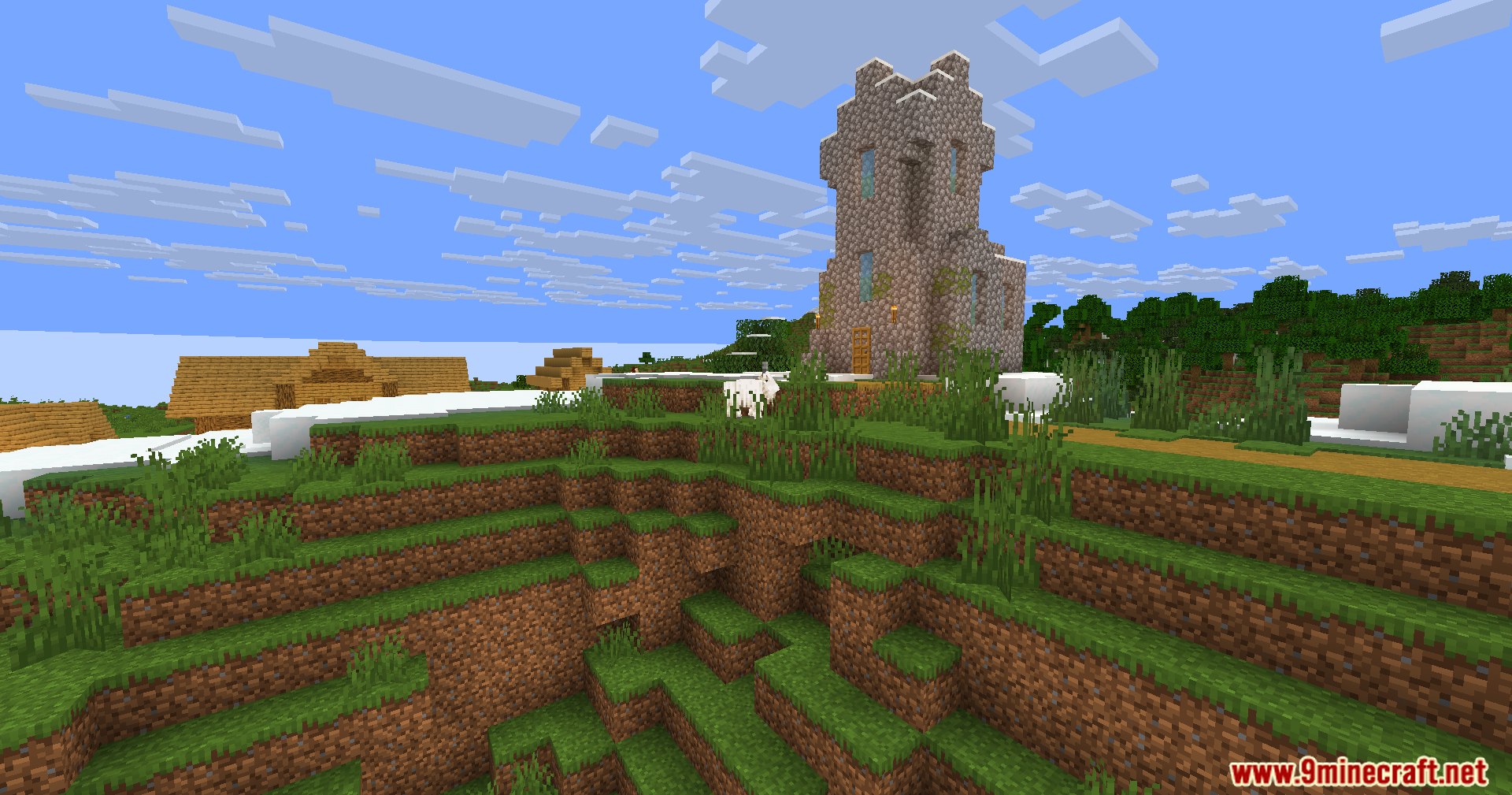 Wozt Vanilla Plus Shaders Screenshot 6 A tall cobblestone church stands on a hill overlooking a grassy landscape