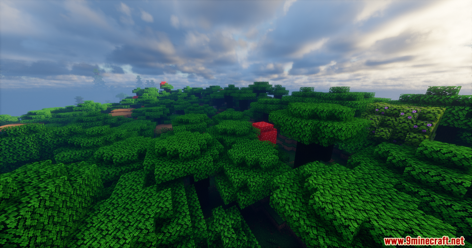 Lush green trees and red mushrooms under a realistic cloudy sky