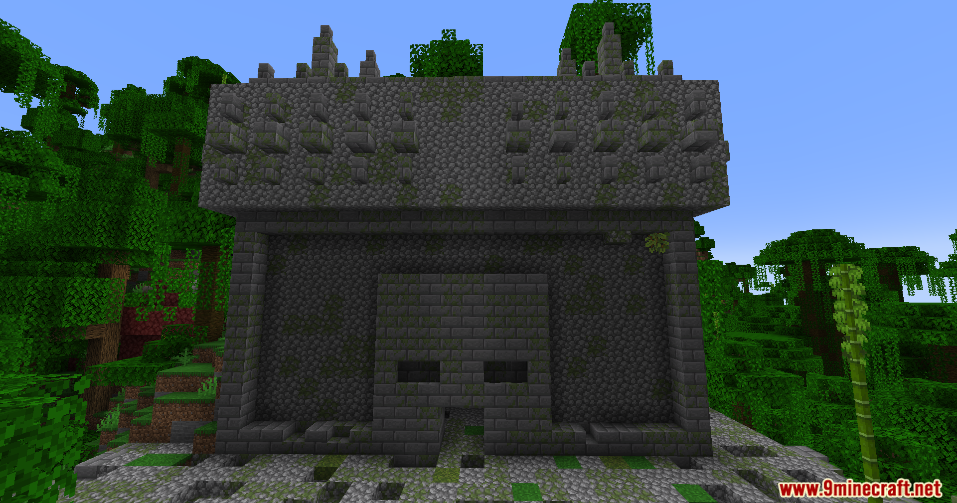 YUNG's Better Jungle Temples Mod Screenshot 3 A large stone jungle temple with a face shaped entrance in the forest