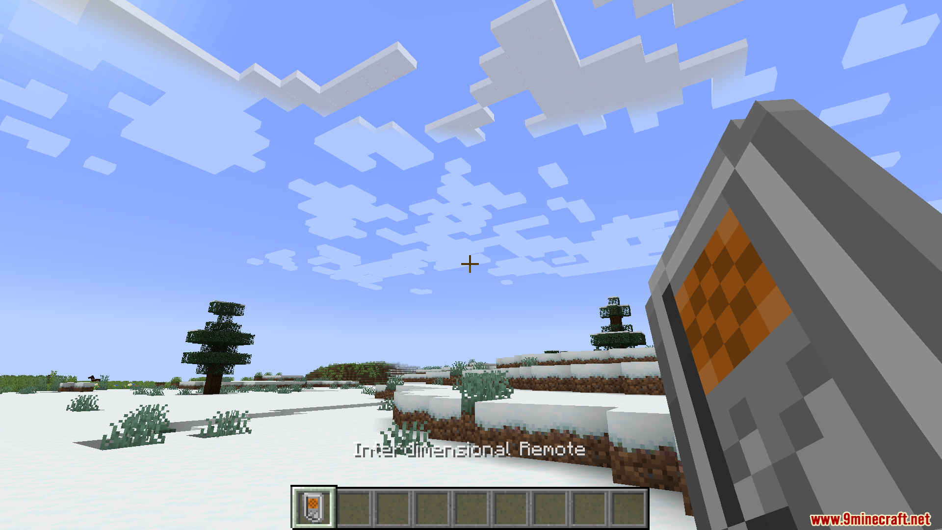 Zhipeiweidu Mod Screenshot 3 A player holds the Interdimensional Remote while standing in a snowy landscape