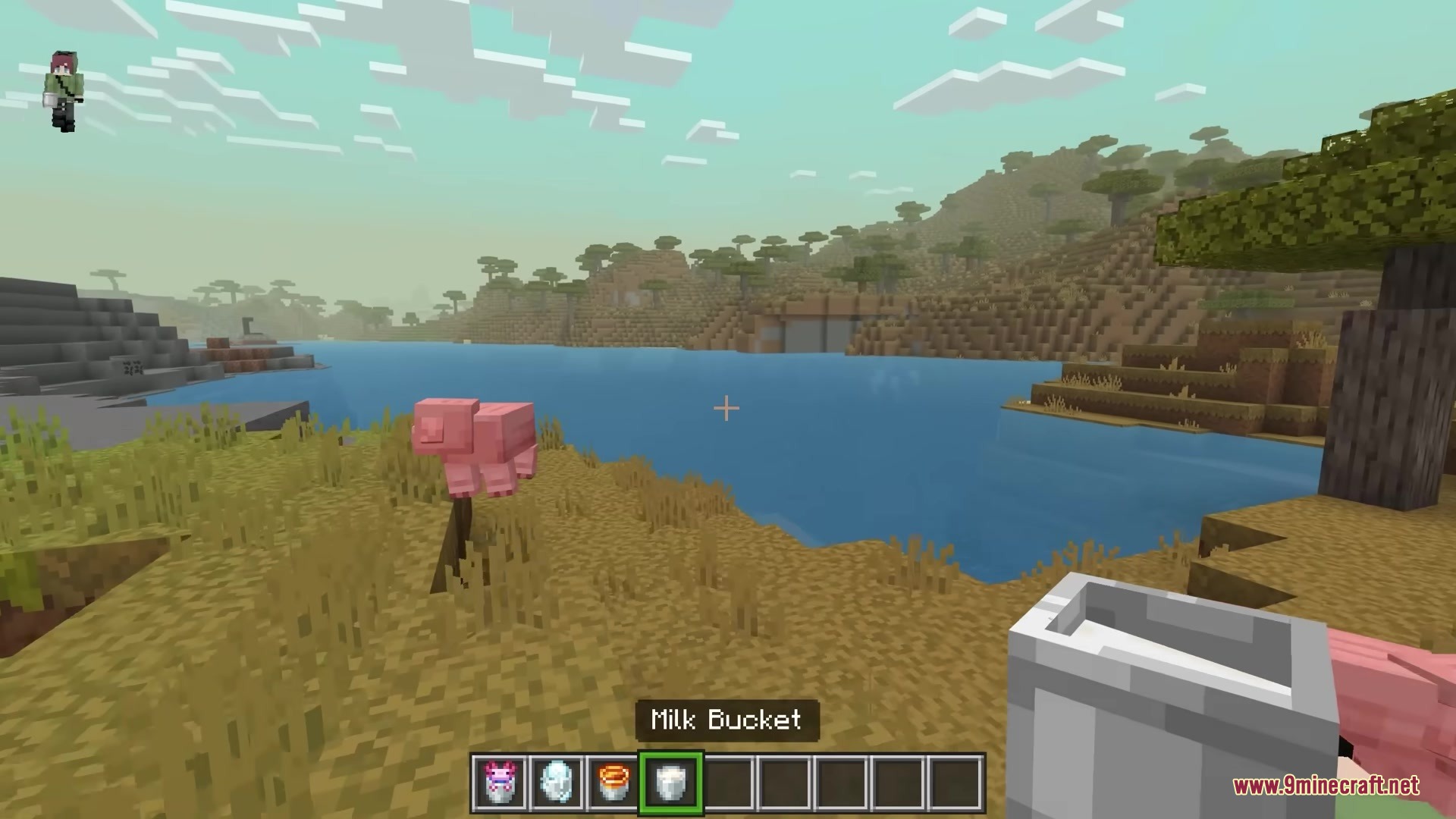 3 D Buckets Resource Pack Screenshot 5 Minecraft player holding a detailed 3D milk bucket in a savanna biome