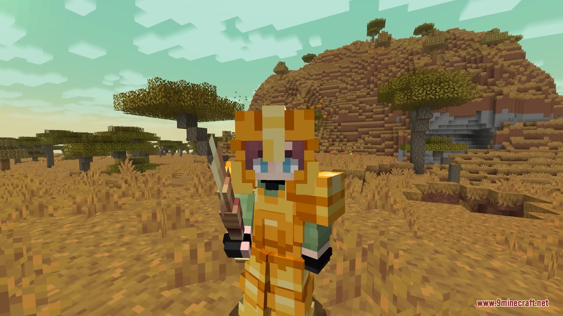 A Minecraft character in gold armor holding a 3D spear in a savanna landscape