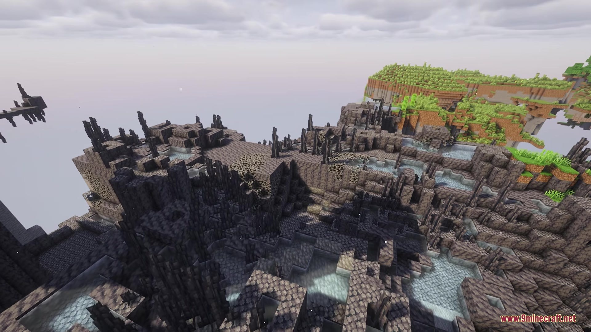 Aero Islands for Create Aeronautics Mod Screenshot 4 Craggy dark terrain with light blue pools overlooking a distant grassy island
