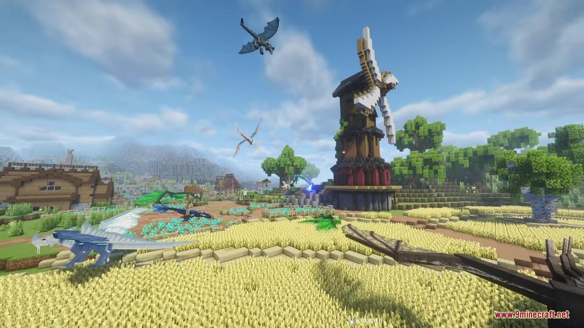 Several dragons fly around a tall windmill and a golden wheat field
