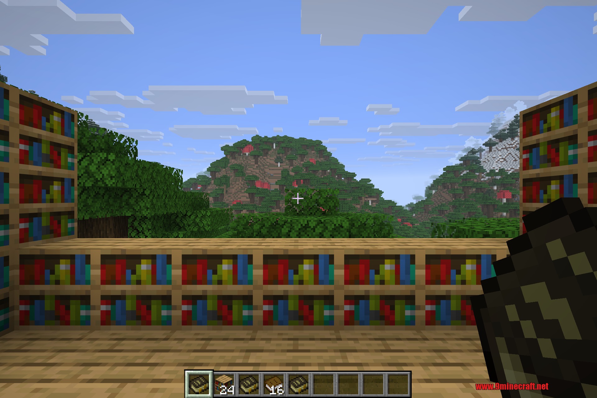 Akashic Tome 9minecraft Mod Screenshot 4 Minecraft player holding an Akashic Tome with multiple manuals in the hotbar