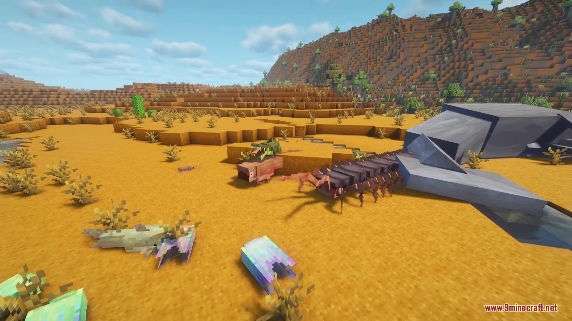 A giant centipede and other unique creatures roaming through a desert biome