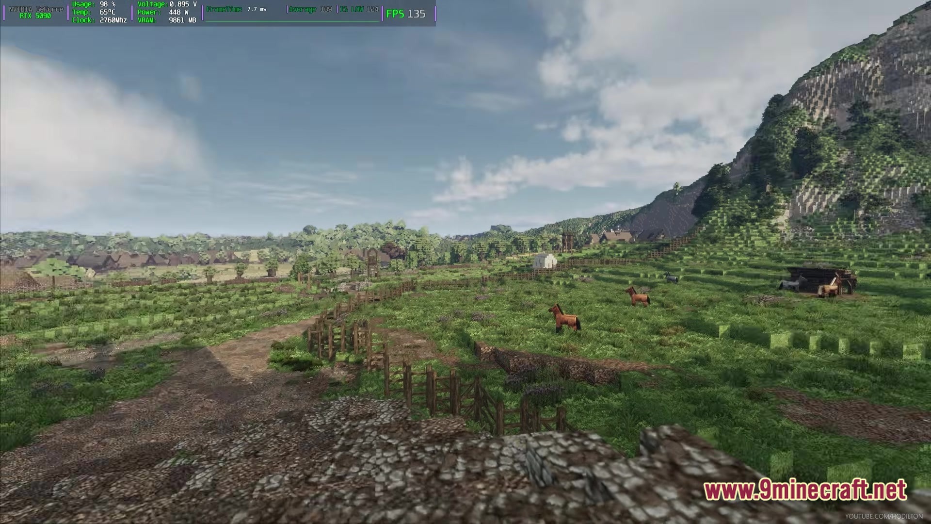 Arda Craft Modpack Screenshot 6 Horses graze in a fenced pasture near a dirt path and a steep, forested mountain