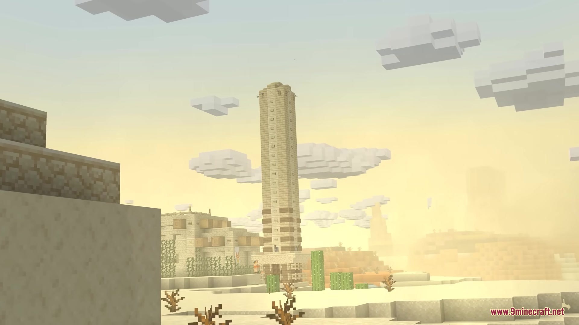 A towering stone obelisk rises above the sandy dunes of a vast desert