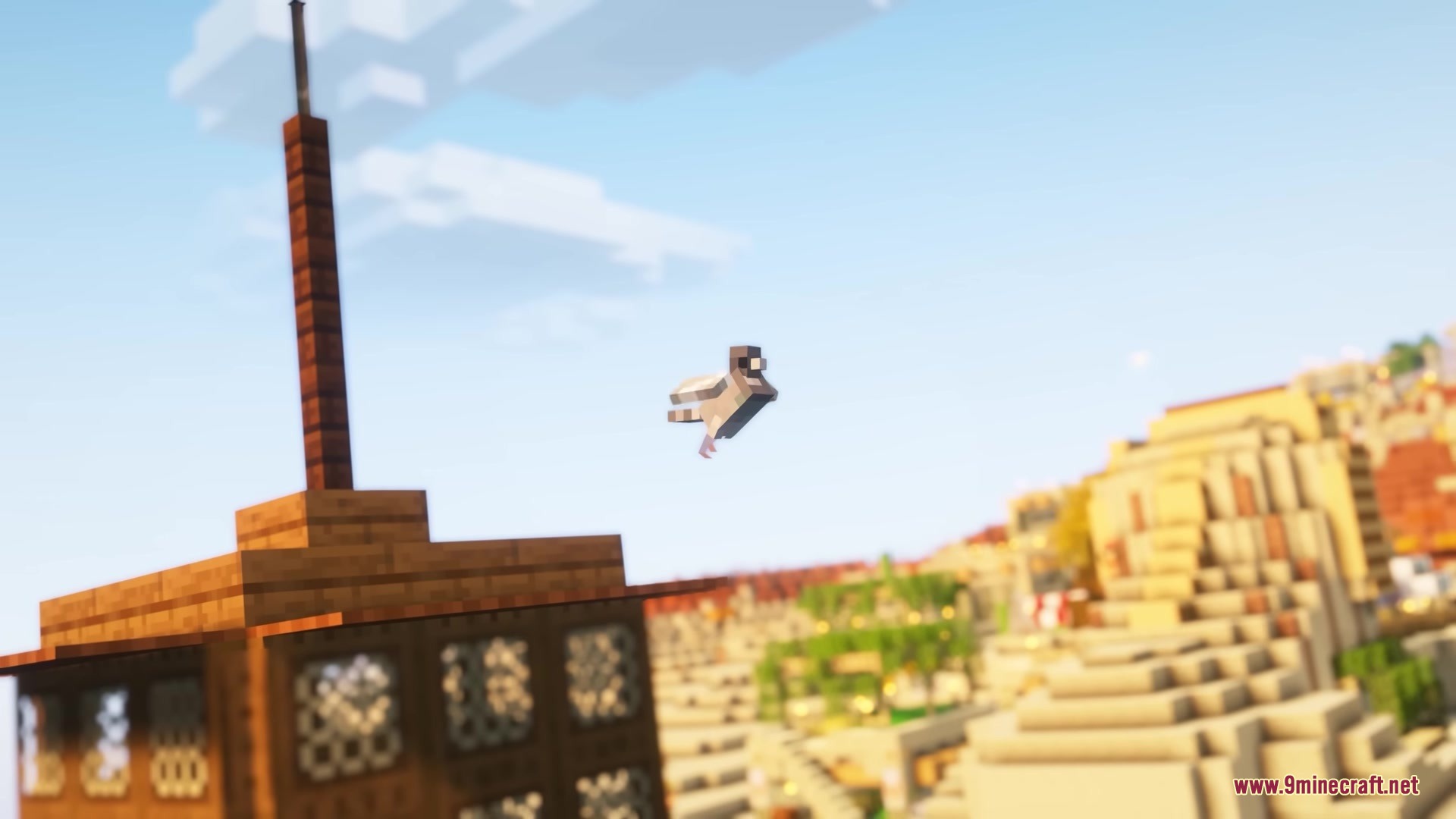 A small pigeon flies through the sky over a sunny desert village